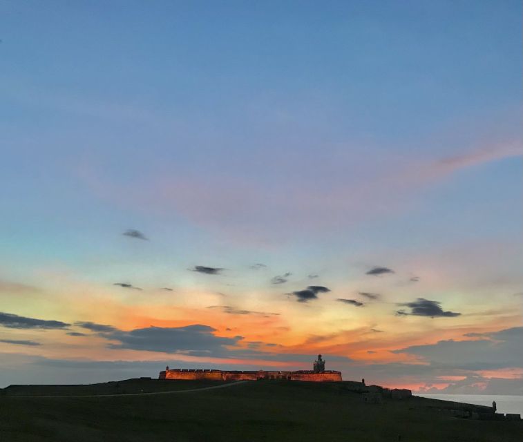 San Juan: Old Town Sunset Walking Tour - Walking toward El Morro as the light changes